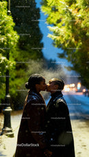 Couple Sharing Tender Kiss on Snowy Winter Evening