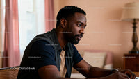 Thoughtful man deeply focused in warm indoor setting