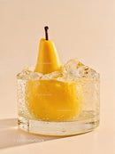 Fresh pear immersed in ice-filled glass on beige