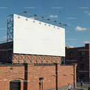 Blank billboard on rooftop above red brick building