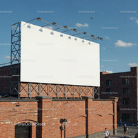 Blank billboard on rooftop above red brick building