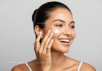 Young Woman Applying Face Moisturizer for Healthy Glowing Skin