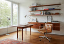 Modern home office with wooden furniture and leather chair