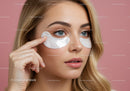 Beautiful Woman Applying Eye Masks for Skincare on a Pink Background