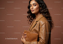 Elegant Woman in Brown Leather Jacket Holding Clutch