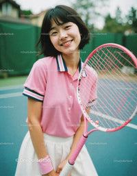 Happy Young Woman Playing Tennis Outdoors with Tennis Racket
