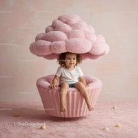 Toddler Sitting in Giant Pink Cupcake Seat