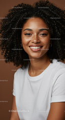 Close-Up of Smiling Woman with Curly Hair and Radiant Skin