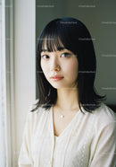 Young Woman with Black Hair and Soft Smile in Indoor Setting
