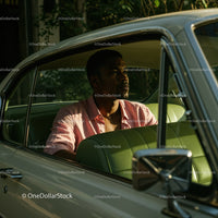 Young Man in Pink Shirt Sitting in Vintage Car on a Sunny Day