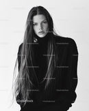 Elegant Female Model in Black Sweater with Long Hair in Studio