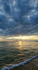 Beautiful Sunset Over Calm Sea With Clouded Sky and Gentle Waves