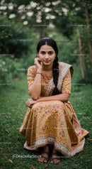 Elegant Woman in Traditional Saree Sitting Outdoors in Green Garden