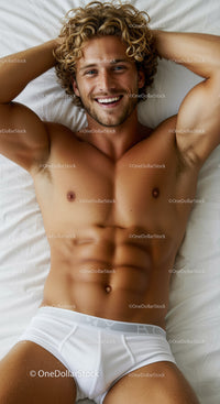 Smiling muscular man relaxing on bed in white underwear
