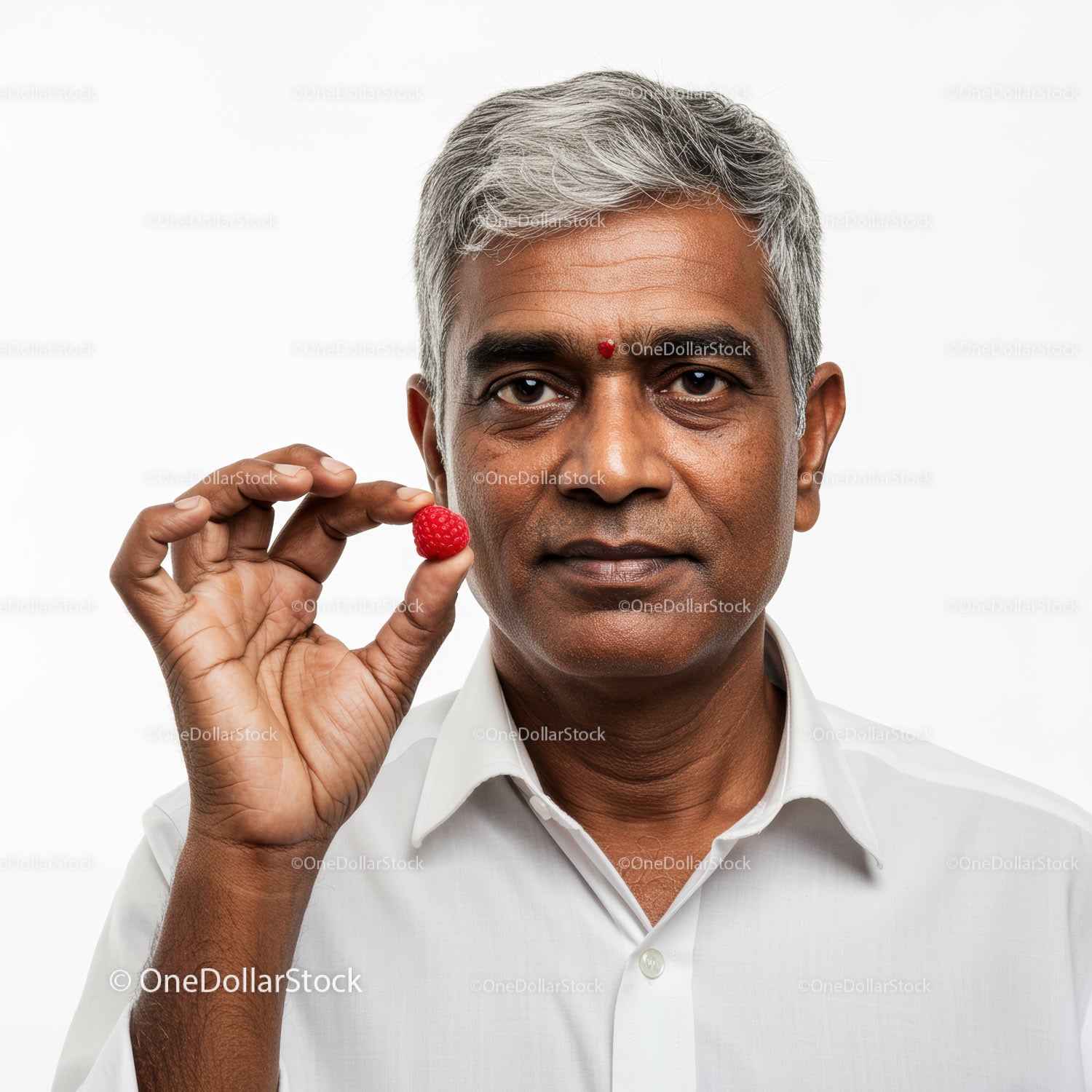 Elderly Man Holding Raspberry with Bright Expression on White Background