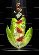 Fresh figs and walnuts falling onto romaine lettuce