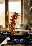 Fresh vegetables tossed in a hot frying pan cooking