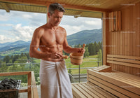 Man Relaxing in Wooden Sauna with Mountain View