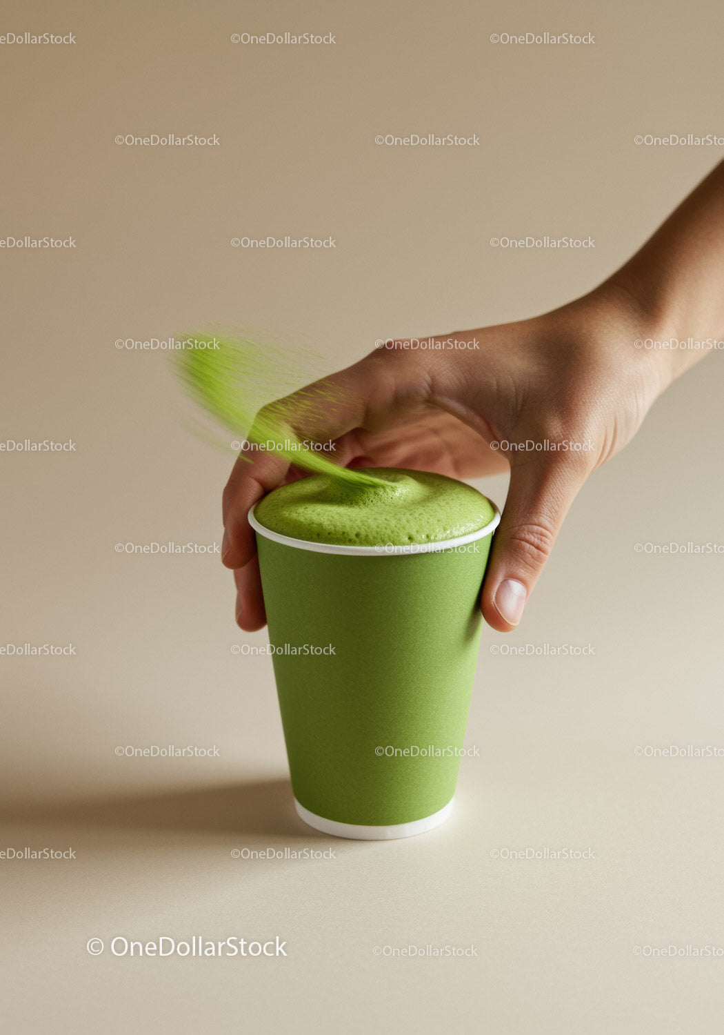 Hand Sprinkling Matcha Powder Over Green Tea Latte