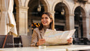 Smiling woman exploring city streets with map