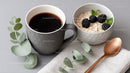 Coffee Cup and Oatmeal with Blackberries in Modern Breakfast Setting