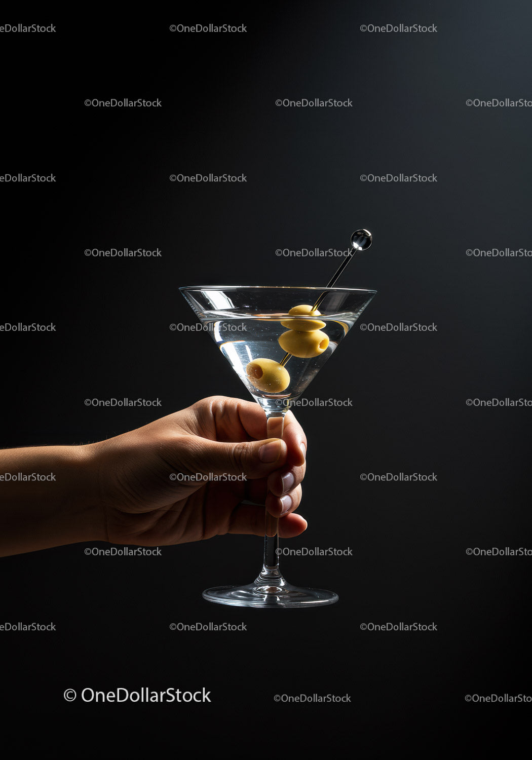 Hand Holding Classic Martini Glass with Olives