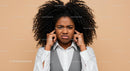 Frustrated Young Woman Covering Ears with Annoyed Expression