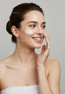 Young Woman Applying Moisturizer with a Bright Smile