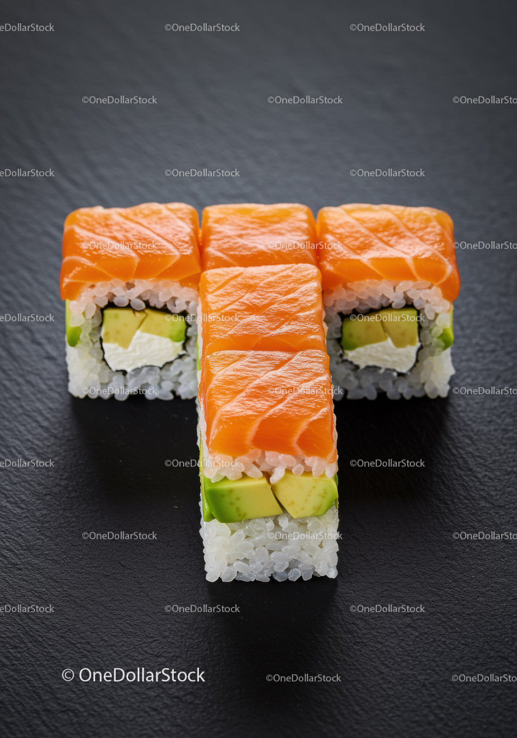 Świeże rolki sushi z łososiem i awokado na czarnej powierzchni