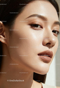 Close-up portrait of young woman with flawless skin