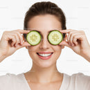 Joyful Woman with Cucumber Slices Over Her Eyes and Bright Smile