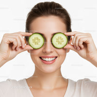 Joyful Woman with Cucumber Slices Over Her Eyes and Bright Smile