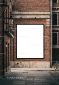 Urban scene with bicycle and blank billboard on brick wall