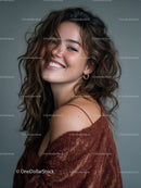 Charming Woman with Curly Hair Smiling in Studio Portrait
