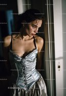 Elegant Woman in Satin Corset Looking Thoughtfully by Window