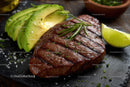 Juicy Grilled Steak with Avocado and Lime on Dark Slate
