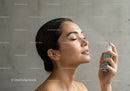 Young Woman Using Facial Mist for Refreshing Skin and Hydration