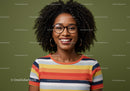 Joyful Woman with Curly Hair Wearing Colorful Striped Shirt and Glasses