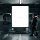 Blurred businessman walking past blank billboard in parking garage