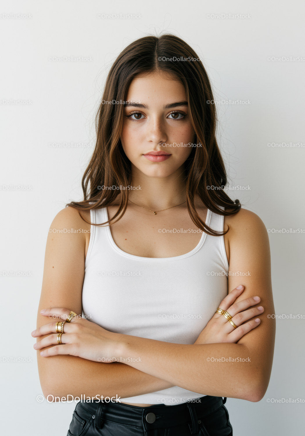 Confident Young Woman in White Tank Top with Crossed Arms