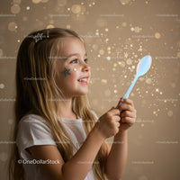 Smiling girl with star stickers holding glowing spoon