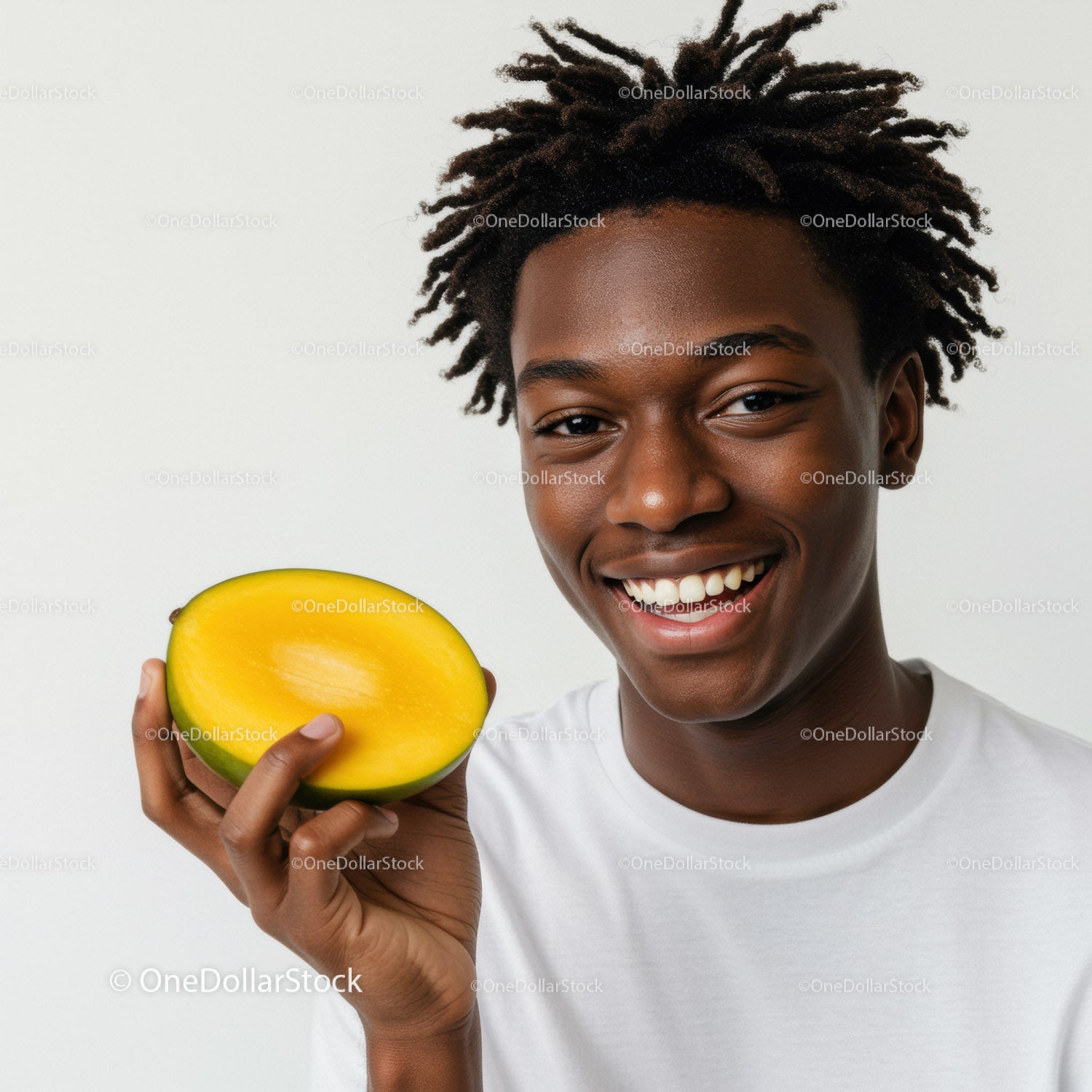 Uśmiechnięty młody mężczyzna trzymający żółte mango w jasnym, swobodnym otoczeniu