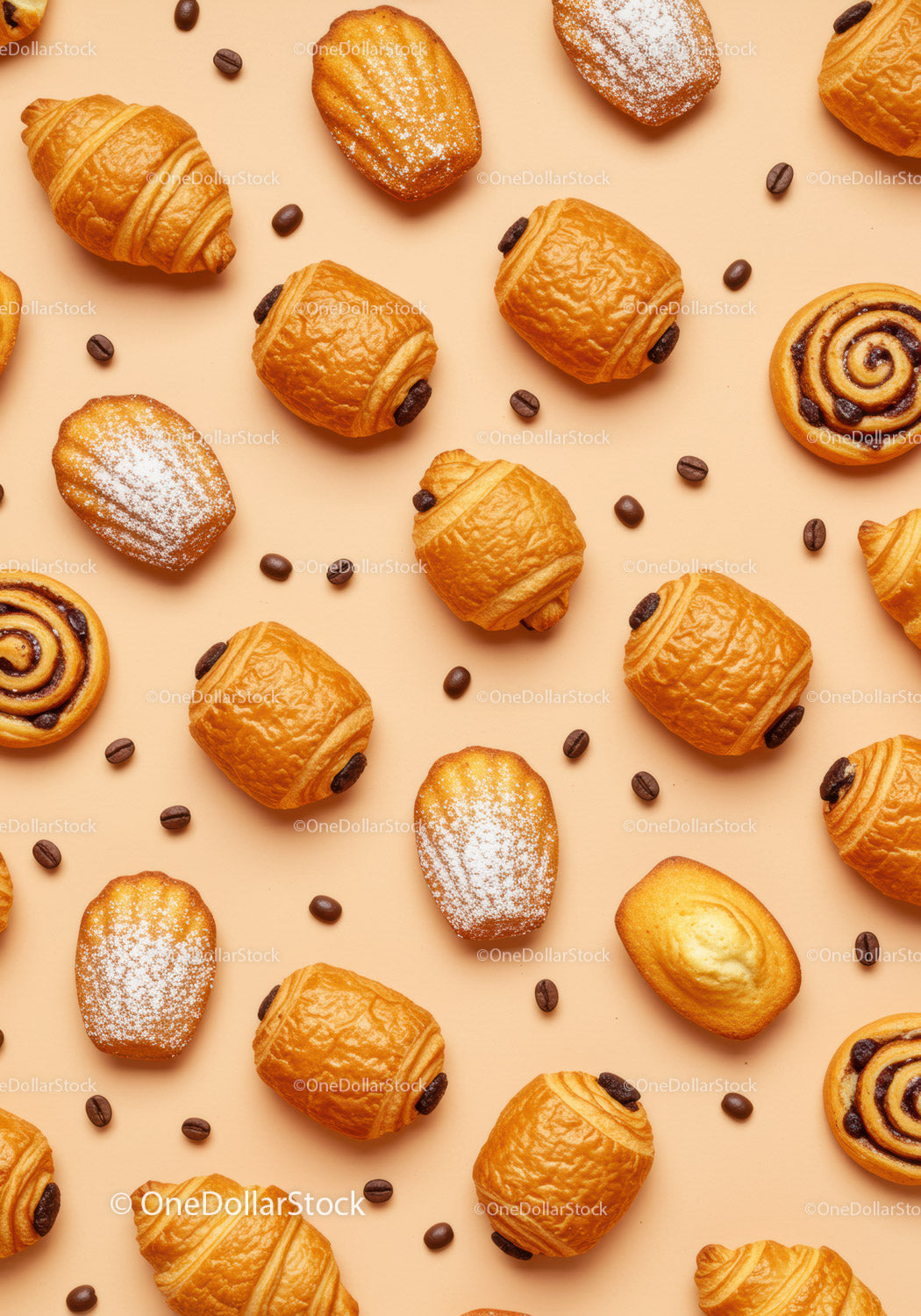 Assorted French pastries and coffee beans on peach background