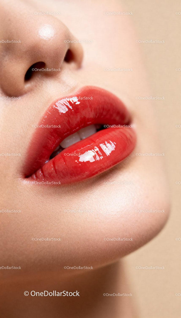 Close-up of glossy red lips with smooth skin