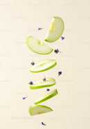 Floating slices of green apple with purple flowers