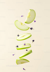 Floating slices of green apple with purple flowers