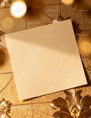 Blank beige paper on textured golden floral surface JPG Mockup Image preview