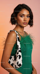 Stylish Woman in Green Dress with Feather Details and Cow Print Bag