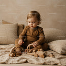 Toddler Playing with Wooden Toys on Cozy Bed