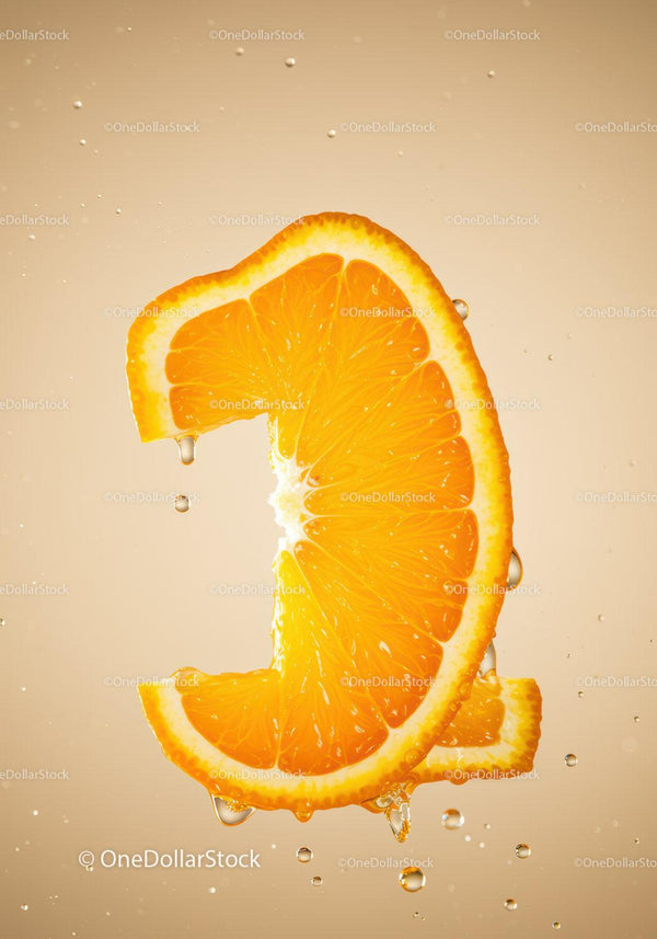 Fresh orange slice dripping with juice in water